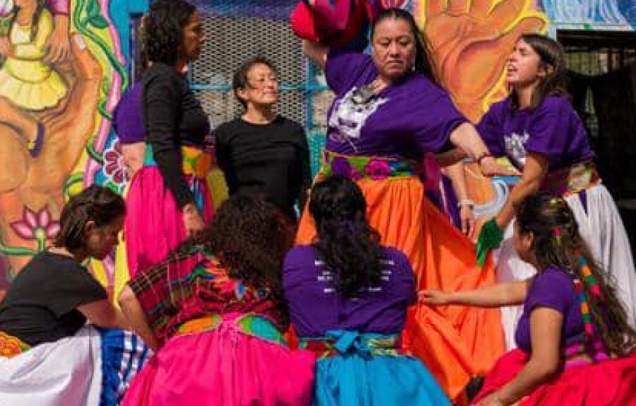 Women dancing in brightly colored clothes